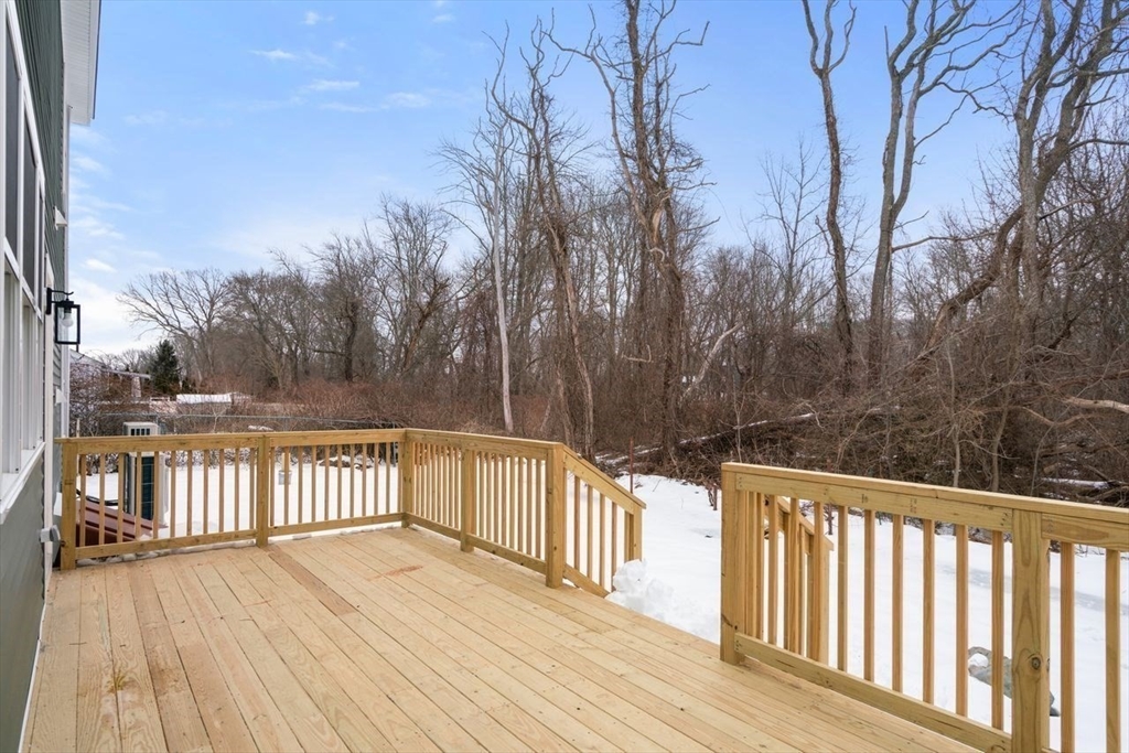 52 Freeman Street Avon, MA 02322 - Photo 16 of 17 a view of a wooden balcony and trees