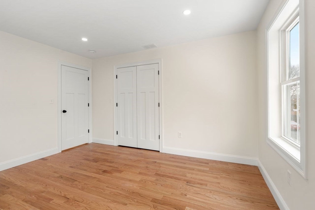52 Freeman Street Avon, MA 02322 - Photo 10 of 17 a view of empty room with window and wooden floor