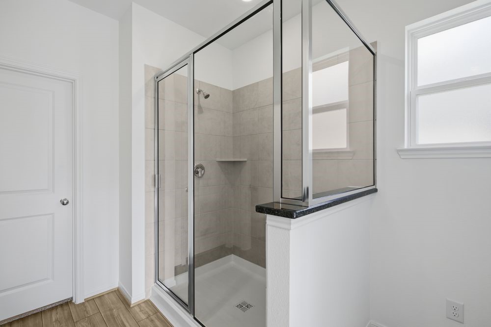 5607 Buttonbush Court Rosenberg, TX 77471 - Photo 11 of 37 a bathroom with a shower and mirror