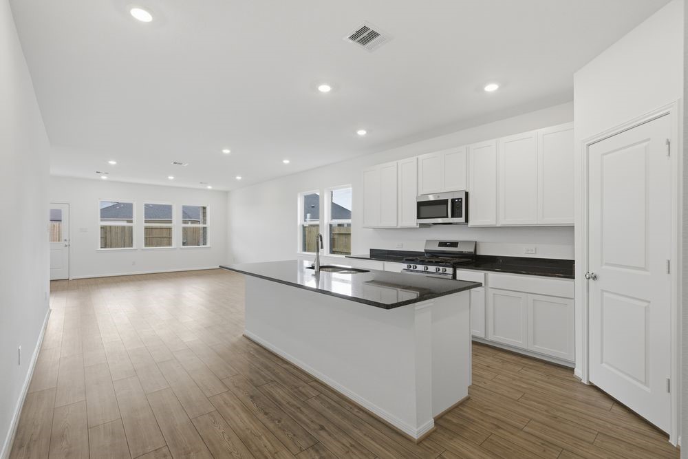 5607 Buttonbush Court Rosenberg, TX 77471 - Photo 3 of 37 a kitchen with stainless steel appliances granite countertop a sink and stove top oven