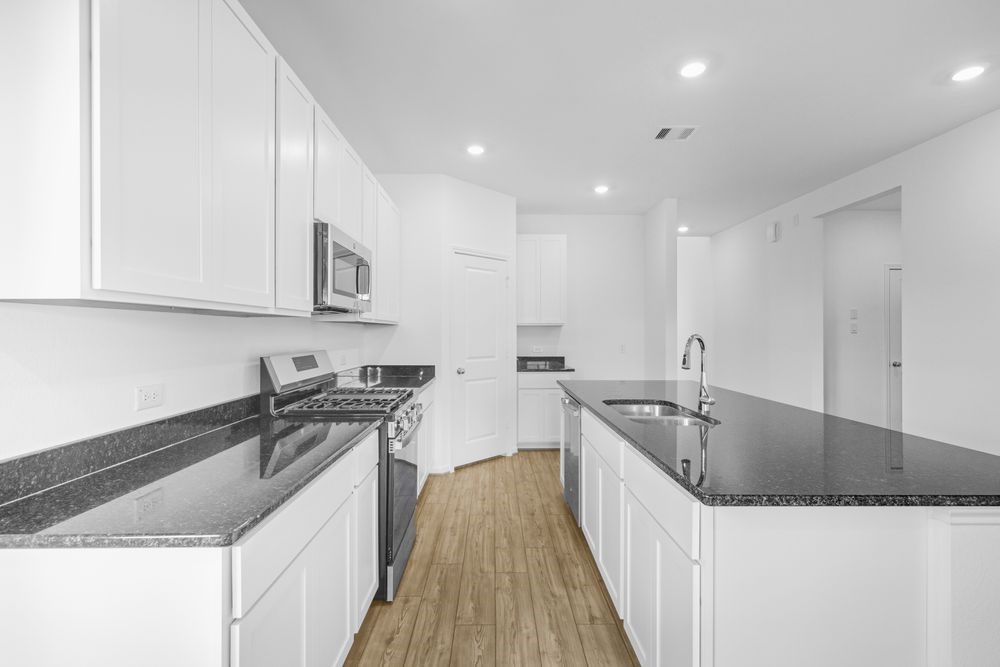 5607 Buttonbush Court Rosenberg, TX 77471 - Photo 6 of 37 a kitchen with stainless steel appliances granite countertop a sink a stove and a wooden floors