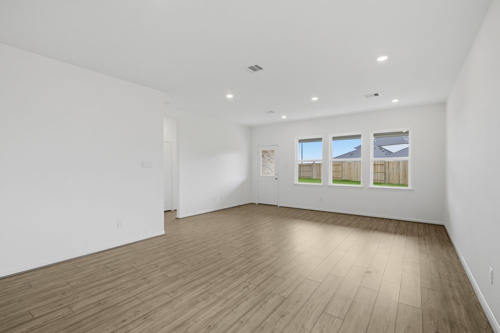 5607 Buttonbush Court Rosenberg, TX 77471 - Photo 7 of 37 a view of an empty room with wooden floor and a window