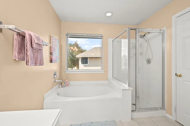 a bathroom with a bathtub and a shower