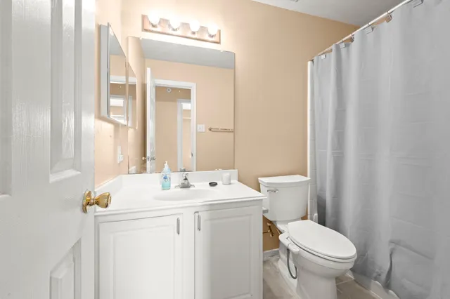 a bathroom with a sink a toilet and a mirror