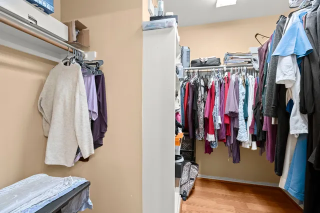 a view of walk in closet with clothes