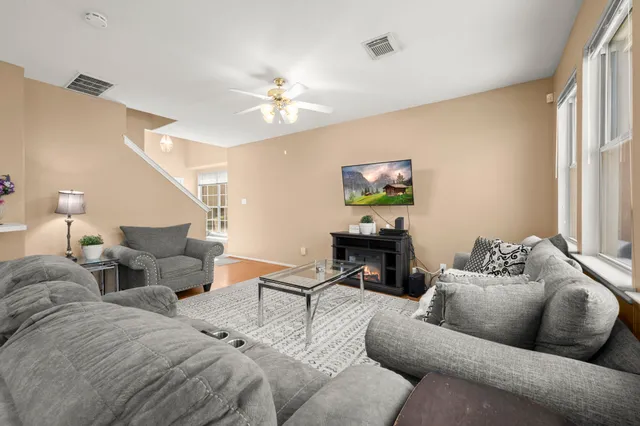 a living room with furniture and a chandelier
