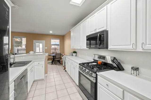 a kitchen with a sink stove and cabinets