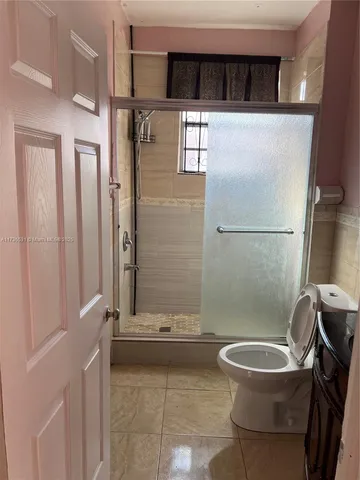 a bathroom with a toilet a sink and a shower