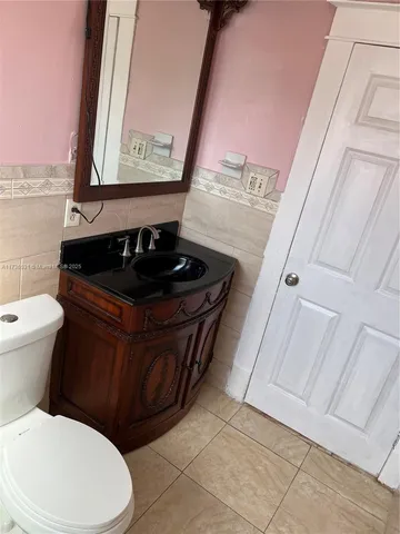 a bathroom with a toilet a sink and a mirror