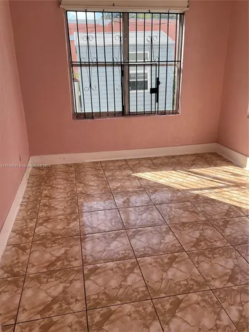 a view of a livingroom with an empty space and window