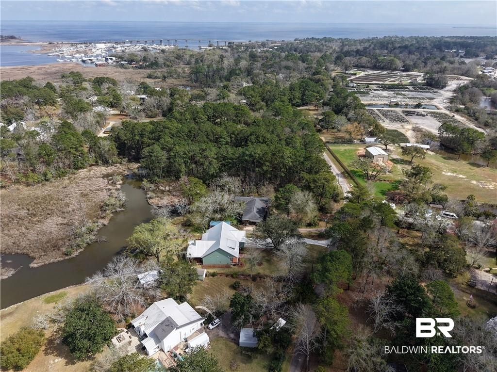 2730 Gator Road Mobile, AL 36605 - Photo 36 of 42 Aerial view of property and surrounding area with a nearby body of water and nearby suburban area