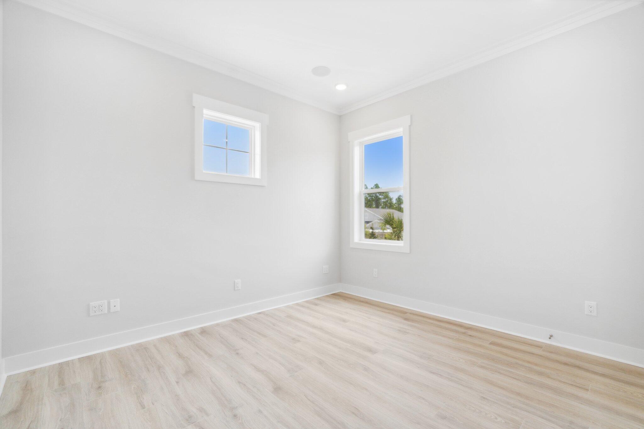 426 Lafayette Road Watersound, FL 32461 - Photo 53 of 78 a view of an empty room with wooden floor and a window