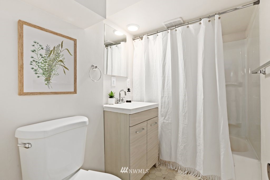 1631 Oakes Avenue Everett, WA 98201 - Photo 27 of 39 a bathroom with a sink a toilet and shower curtain
