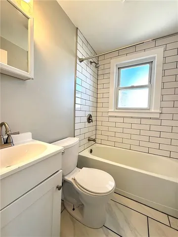 a bathroom with a toilet a sink and bathtub