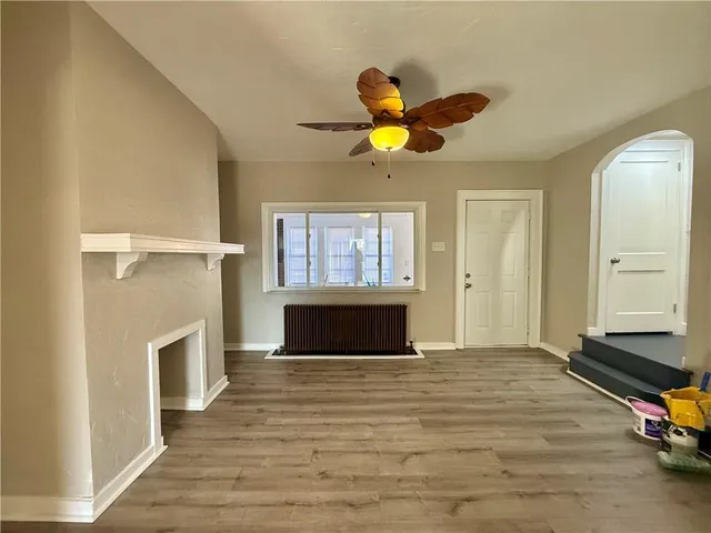 a living room with fireplace furniture and a window