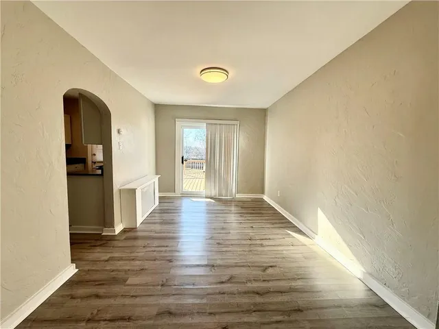 a view of a room with wooden floor and staircase