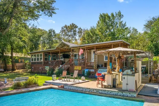 a front view of house with yard and outdoor seating