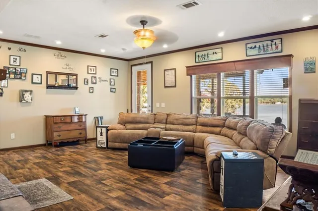a living room with furniture and large windows