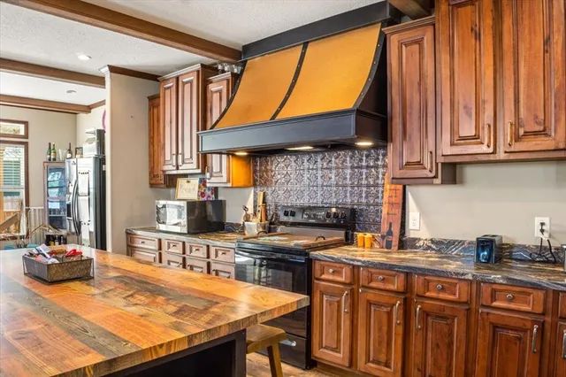 a kitchen with stainless steel appliances a stove a sink and a refrigerator