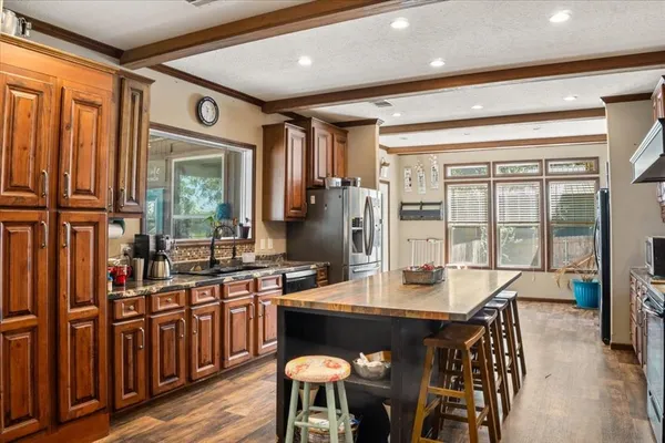 a kitchen with a table chairs stove and cabinets