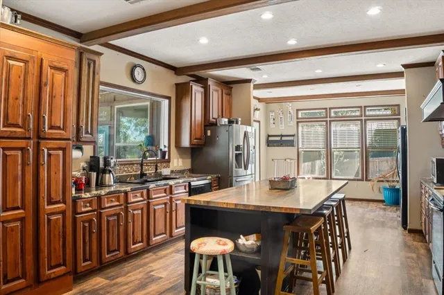 a kitchen with a table chairs stove and cabinets