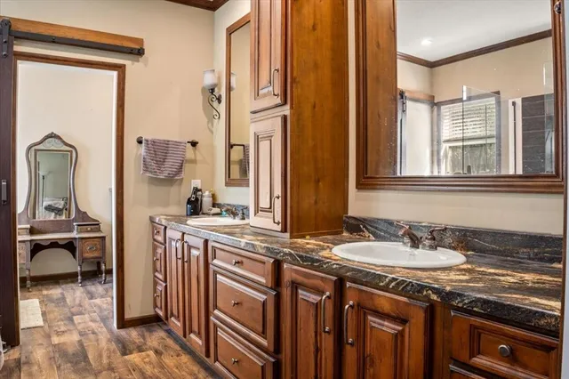 a spacious bathroom with a granite countertop sink and a mirror