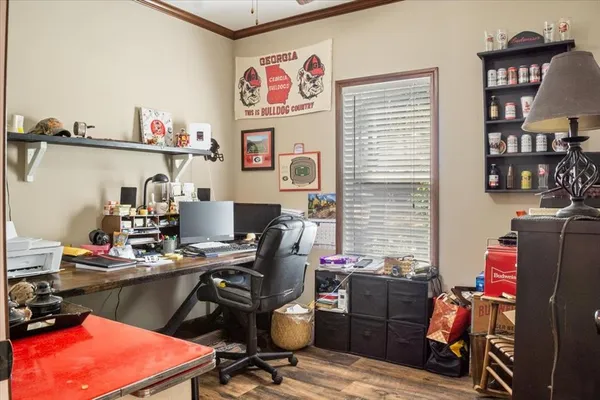 a view of a workspace with furniture and a window