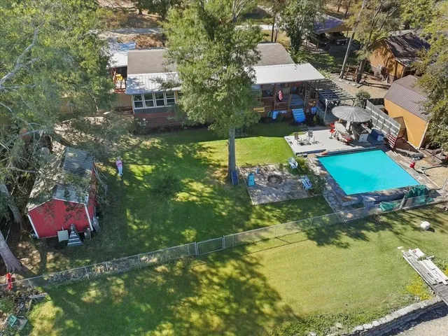 an aerial view of a house with yard swimming pool and outdoor seating