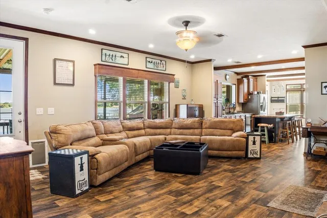a living room with furniture and large windows