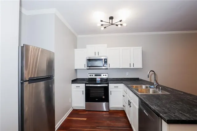 a kitchen with a sink a stove and refrigerator