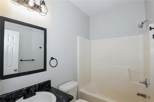 a bathroom with a toilet a sink and bathtub
