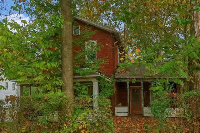 front view of a house with a tree