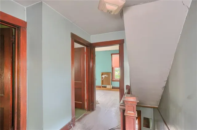 a hallway with kids room bathroom