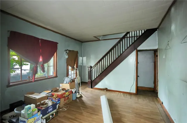 a view of a livingroom with furniture and stairs