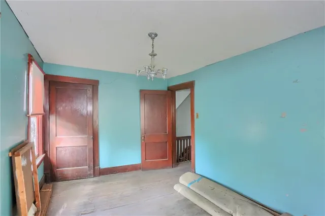 an empty room with closet and windows