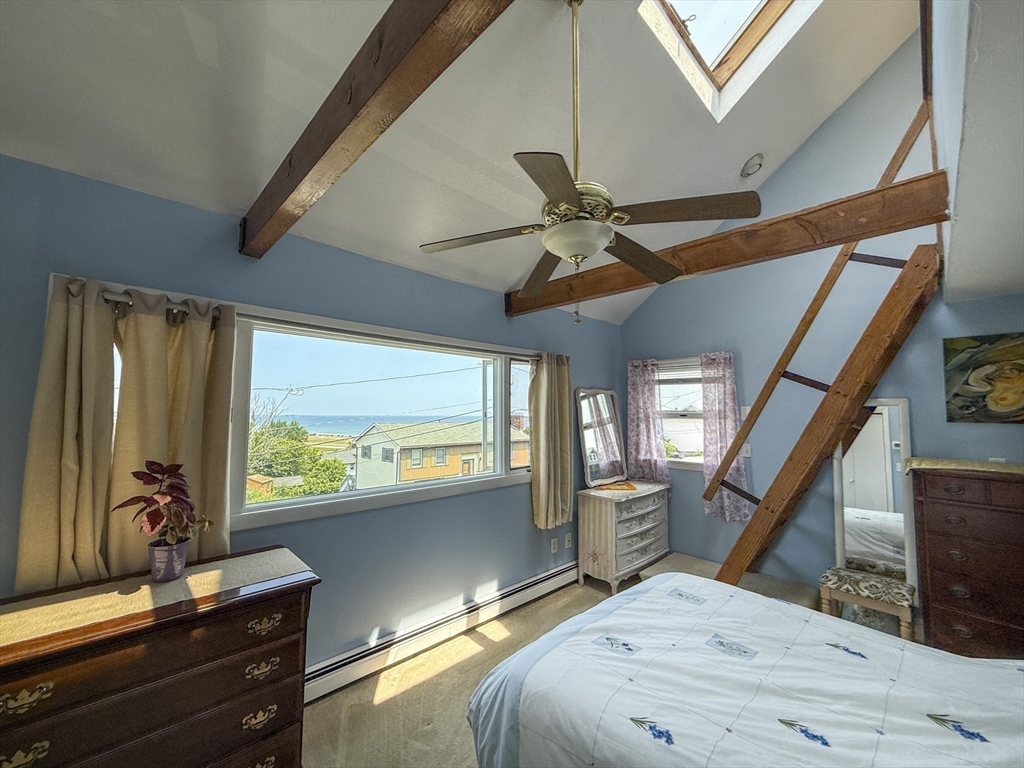 26 Merrill Road, Unit 26 Hull, MA 02045 - Photo 17 of 24 a bedroom with a bed dresser and a large window