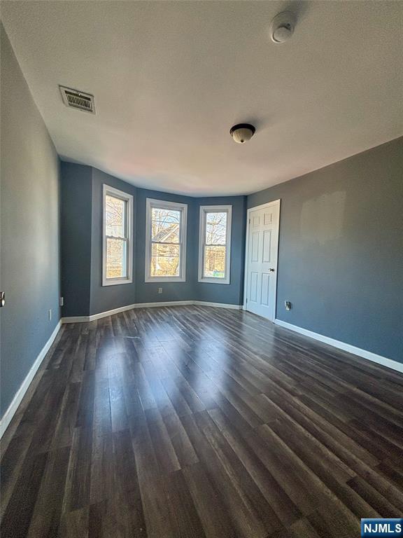 792 South 15th Street, Unit 2 Newark, NJ 07108 - Photo 2 of 10 a view of an empty room with wooden floor and window