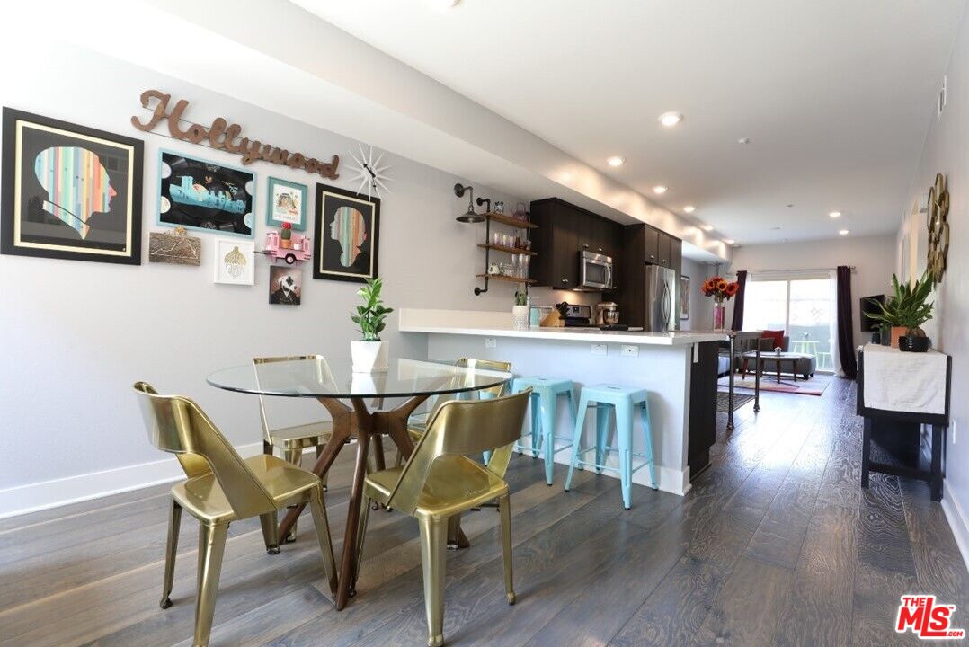 a view of a dining room with furniture and wooden floor