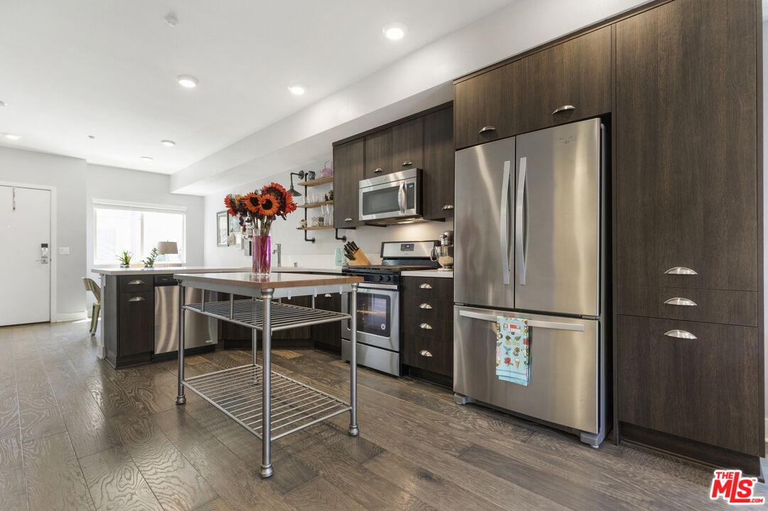 2972 Ripple Place, Unit 101 Los Angeles, CA 90039 - Photo 11 of 46 a kitchen with stainless steel appliances a refrigerator stove microwave and cabinets
