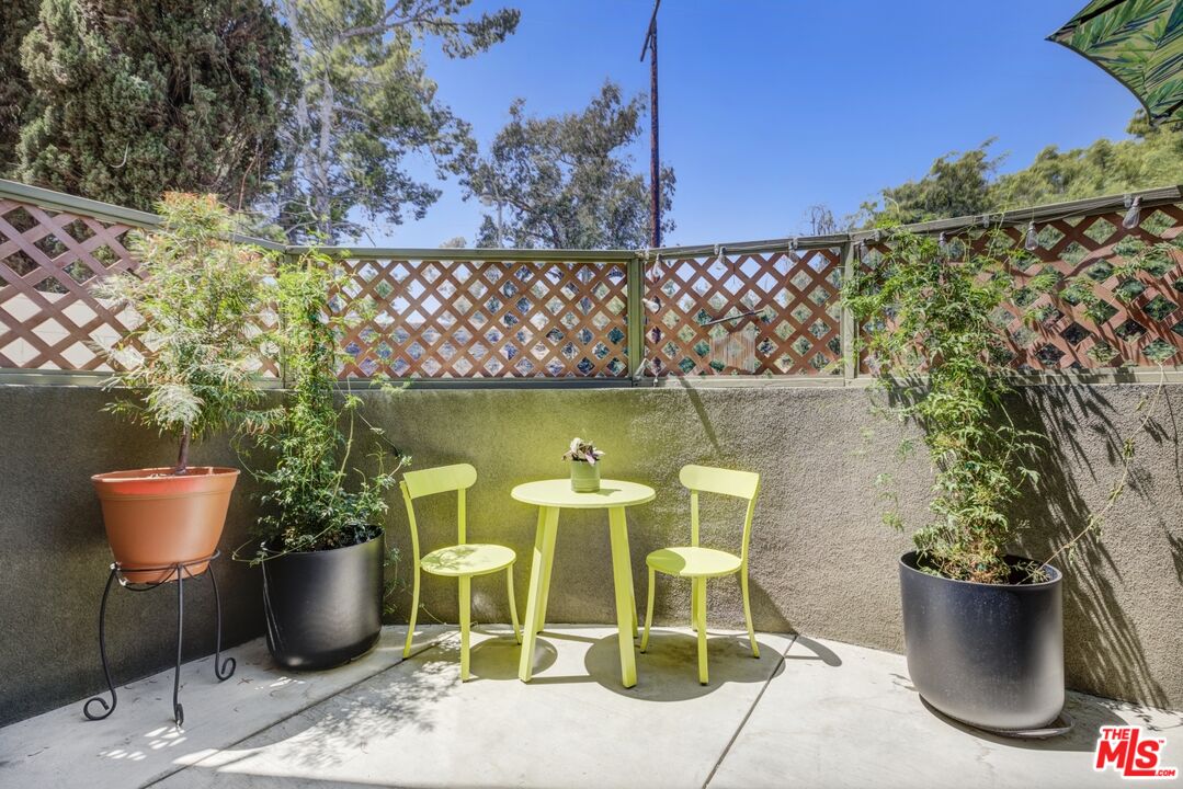 2972 Ripple Place, Unit 101 Los Angeles, CA 90039 - Photo 18 of 46 a view of a patio with table and chairs potted plants