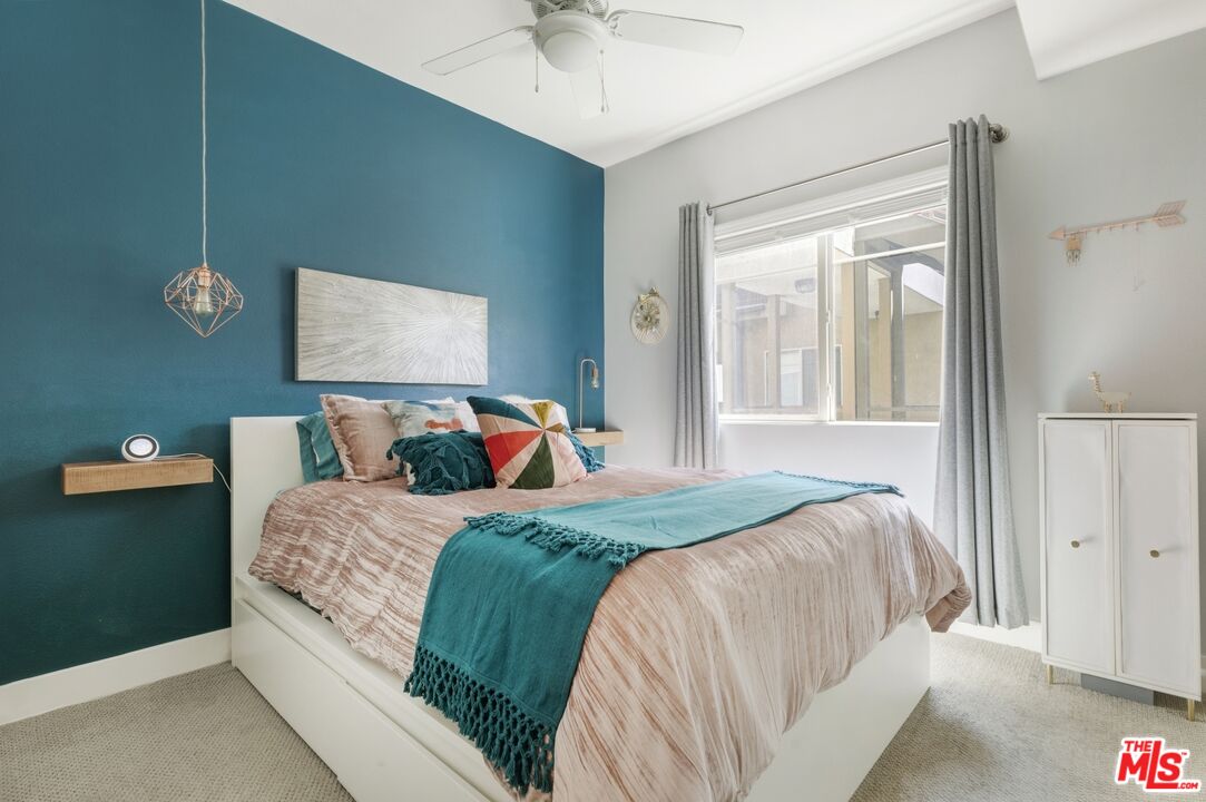 2972 Ripple Place, Unit 101 Los Angeles, CA 90039 - Photo 21 of 46 a bedroom with a large bed and a chandelier