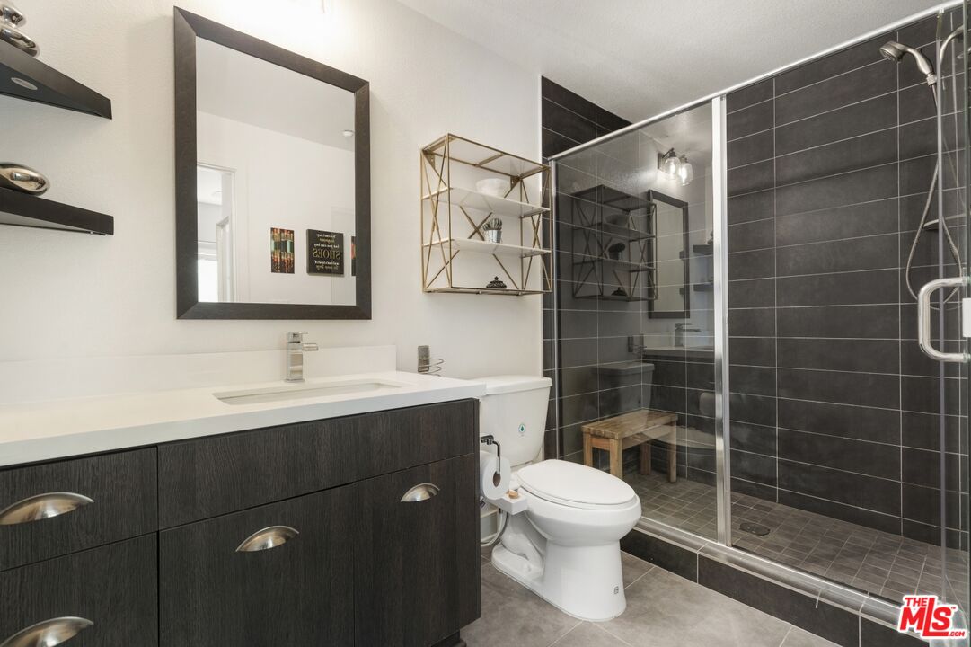2972 Ripple Place, Unit 101 Los Angeles, CA 90039 - Photo 24 of 46 a bathroom with a shower toilet sink and mirror