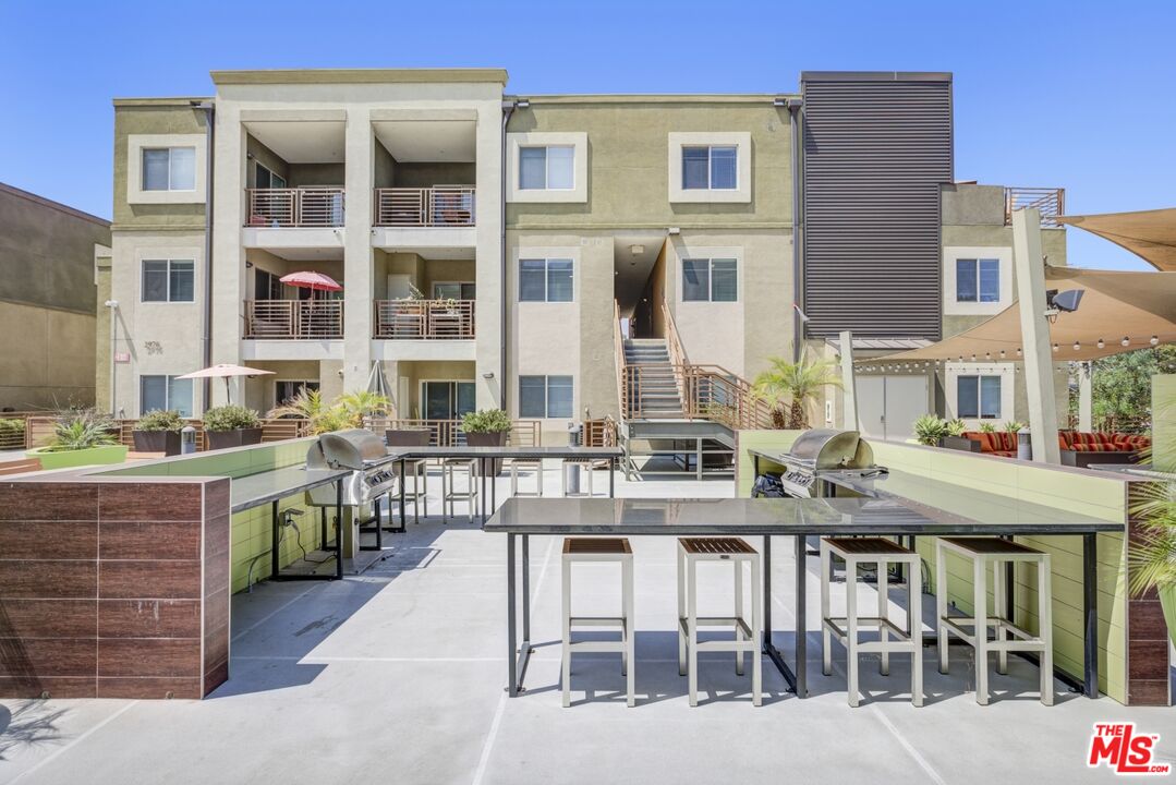 2972 Ripple Place, Unit 101 Los Angeles, CA 90039 - Photo 36 of 46 a view of a brick building with a bench in front of building