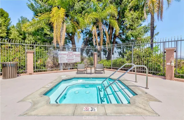 a view of a swimming pool with a patio and a garden
