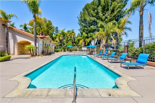 a swimming pool view with a outdoor seating