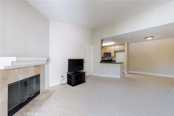 a view of living room with furniture and a fireplace