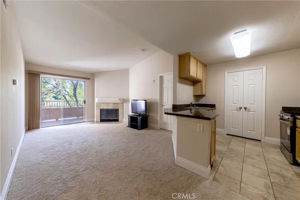 a kitchen with granite countertop a sink and a stove top oven