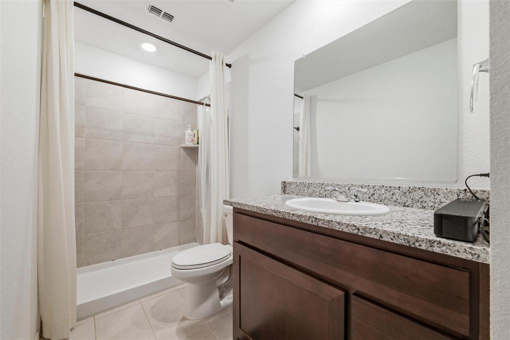 421 Corsair Way Ferris, TX 75125 - Photo 18 of 34 Full bath featuring vanity, a shower stall, light tile patterned floors, and recessed lighting