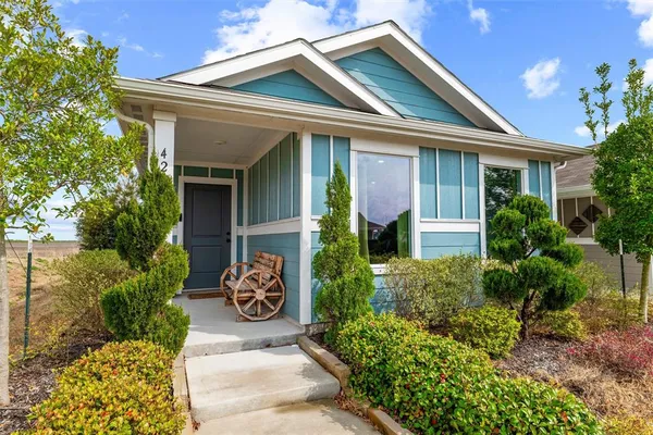 a front view of a house with potted plants
