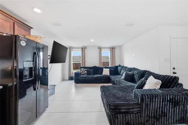 a front view of a house with a yard and potted plants